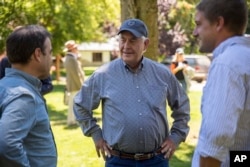 U.S. Secretary of State Rex Tillerson, center, meets with locals at a horse riding operation in Bariloche, Argentina, Feb. 3, 2018.