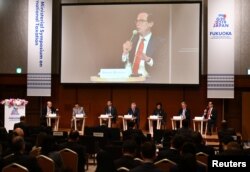 U.S. Secretary of Treasury Steven Mnuchin, right, on podium, delivers a speech during the G20 Ministerial Symposium on International Taxation in the G20 Finance Ministers and Central Bank Governors meeting in Fukuoka, Japan, June 8, 2019.