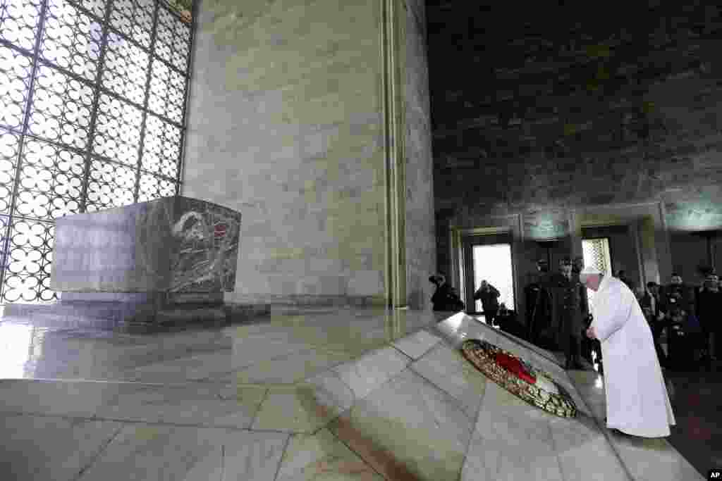 Pope Francis pauses after laying a wreath at the grave site of the Turkey's founder, Mustafa Kemal Ataturk, in Ankara.