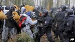 Anti-nuclear activists stand in front of the German riot police during clashes near Leitstade, northern Germany, 07 Nov 2010.