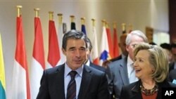 US Secretary of State Hillary Rodham Clinton, right, walks with NATO Secretary-General Anders Fogh Rasmussen after a NATO meeting, Thursday Oct. 14, 2010 at NATO headquarters in Brussels. Clinton arrived in Brussels following a two-day tour of the Balkans