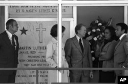 FILE - President Jimmy Carter and first lady Rosalynn Carter talk with Coretta Scott King and United Nations Ambassador Andrew Young during a stop at the site where Martin Luther King was assassinated, in Memphis, Dec. 9, 1978.