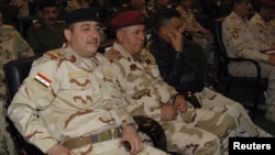 Commander of the army's Seventh Division, Maj. Gen Mohammed Ahmed al-Kurwi, left, attends Ministry of Defence conference, Baghdad Dec. 14, 2013.