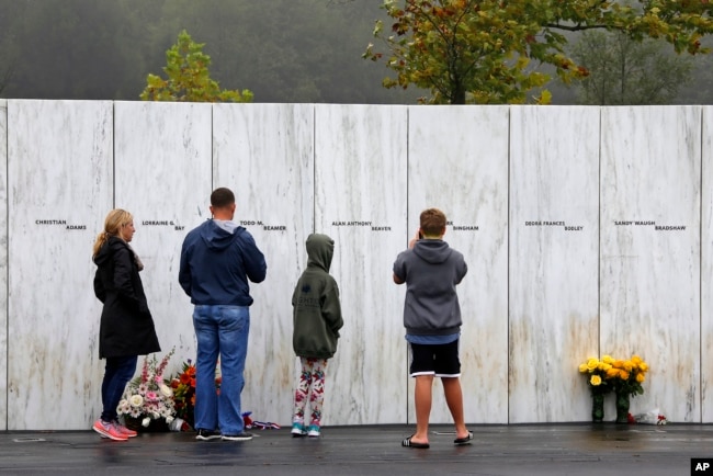 Visitors to the Flight 93 National Memorial in Shanksville, Pa., participate in a sunset memorial service on Monday, Sept. 10, 2018, as the nation marks the 17th anniversary of the Sept. 11, 2001 attacks.