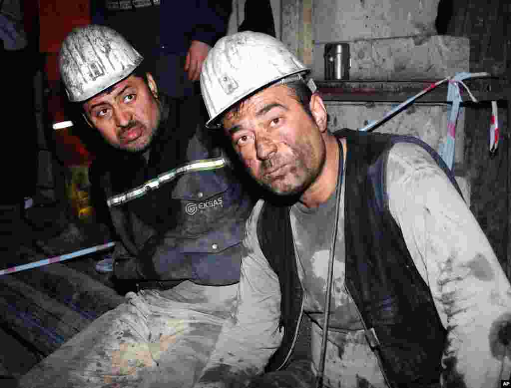 Two rescued miners sit waiting after an explosion and fire at a coal mine, in Soma, western Turkey, May 13, 2014.
