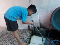 Seorang warga Perumahan Kembang Putih, Bantul, DI Yogyakarta menggunakan air PDAM. (Foto courtesy: Hernawan)