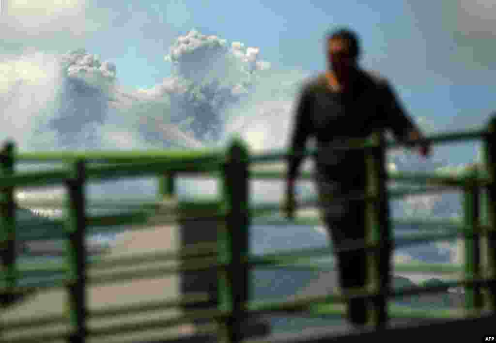 The view from Tambillo, Ecuador, of the Cotopaxi volcano spewing ash. Nearly 325,000 people could be affected by an eruption the volcano looming beyond the country's capital Quito. The biggest risk is from an eruption melting the 5,900-meter (19,000-foot) mountain's snowcap and triggering massive melt-water floods and lahar mudflows that could sweep through nearby towns.