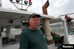 Lobsterman Perley Frazier poses on his boat,Jericho's Way, in Stonington, Maine, July 7, 2017.