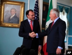 El secretario de Estado de EEUU, Rex Tillerson (der.) saluda al canciller mexicano Luis Videgaray en el Departamento de Estado, durante una visita del segundo el 30 de agosto de 2017.