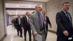 Members of Congress arrive for a closed-door intelligence briefing on Capitol Hill, Jan. 13, 2017.