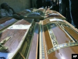 Coffins of Coptic Christian victims from Sunday's violence are readied for funeral procession, Cairo, Egypt, October 10, 2011.