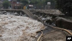 Train tracks lay destroyed in a flooded river in the Chosica district of Lima, Peru, Sunday, March 19, 2017. Intense rains and mudslides over the past three days have wrought havoc around the Andean nation.
