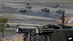 FILE - A U.S.-made HIMARS (High Mobility Advanced Rocket System) is displayed amid armored personnel carriers after taking part in a U.S.-Philippine military exercise April 14, 2016, at Crow Valley, north of Manila.