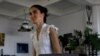 Yoanis Sanchez, who writes the "Generation Y" blog, walks inside her home in Havana, Friday, April 11, 2008. 