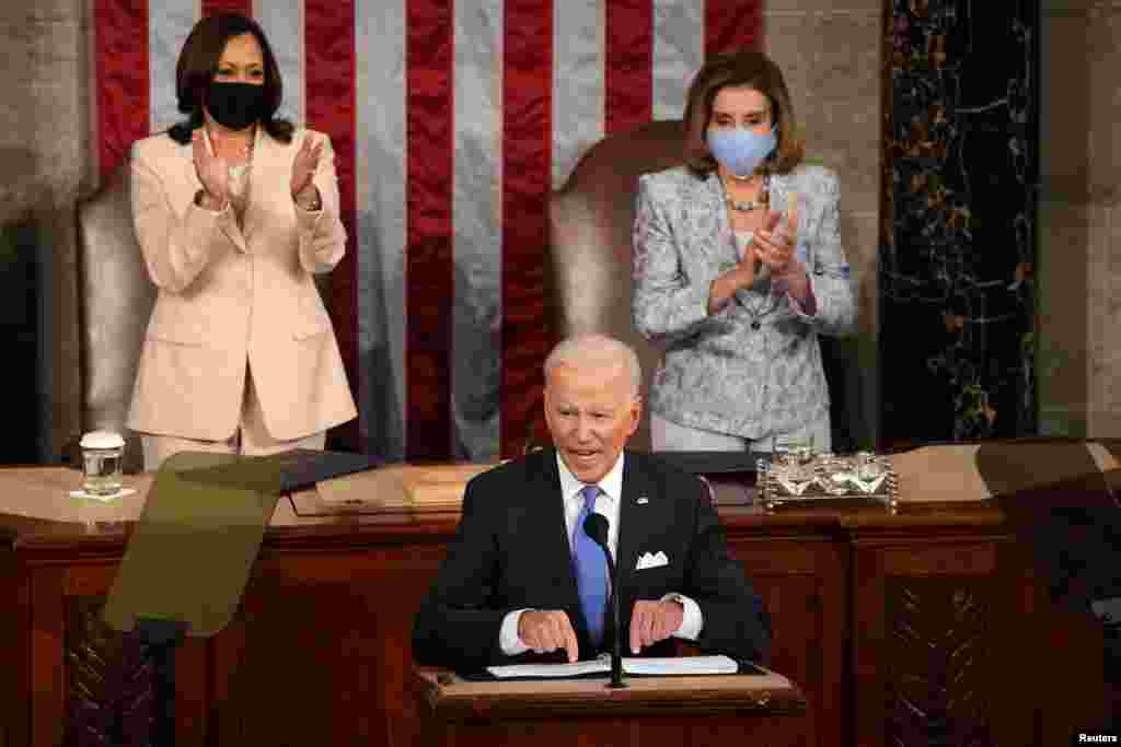 U.S. Vice president Kamala Harris and Speaker of the House Nancy Pelosi applaud as President Joe Biden addresses to a joint session of Congress in the House chamber of the U.S. Capitol in Washington, April 28, 2021.