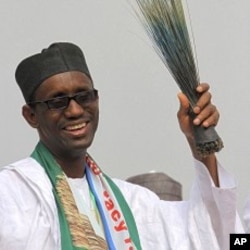 Former anti-graft chief and presidential flagbearer Nuhu Ribadu with a broom, a party symbol, reacts after his announcement as a consensus candidate during the presidential primaries of Action Congress of Nigeria (ACN) in Lagos, 14 Jan 2011.