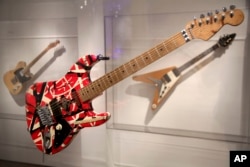 A guitar made and played by Eddie Van Halen of Van Halen is displayed at the exhibit "Play It Loud: Instruments of Rock & Roll" at the Metropolitan Museum of Art in New York, April 1, 2019.