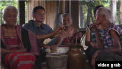 A picture screenshot from the documentary video “Our Tribe-Our Heritage” shows a group of elders with their chin tattooed. 
