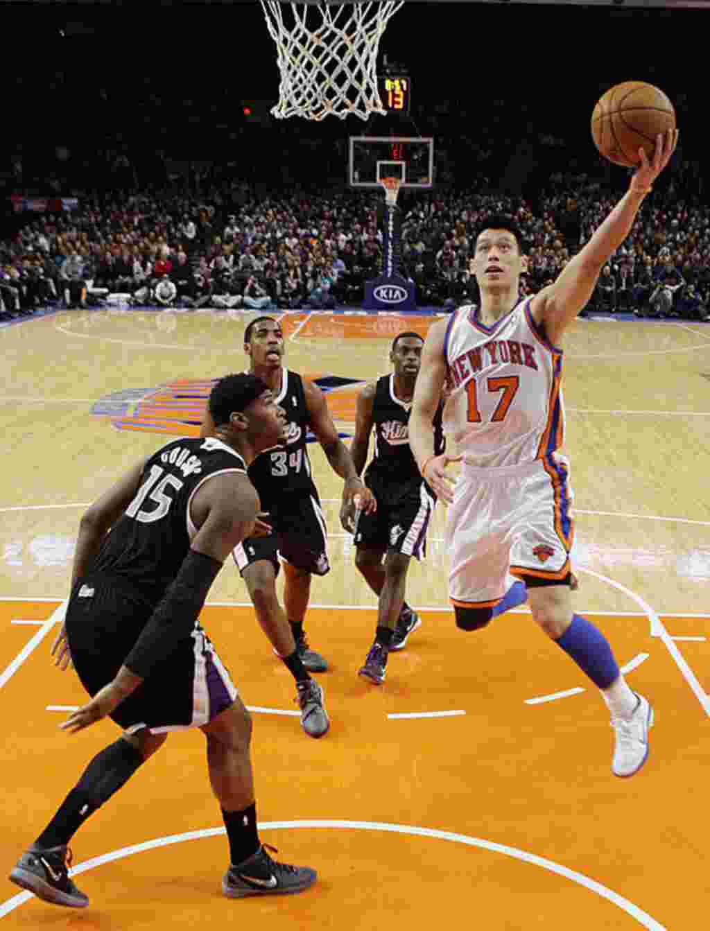 New York Knicks' Jeremy Lin drives past Sacramento Kings' DeMarcus Cousins during an NBA basketball game on February 15, 2012, in New York. Lin had 10 points and 13 assists as the Knicks won the game 100-85. (AP)