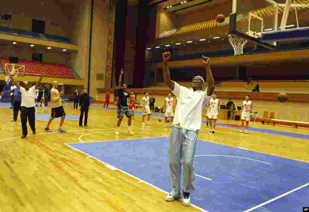 Dennis Rodman cheers after a fellow basketball player makes a jump shot during a practice session with North Korean players in Pyongyang, Jan. 7, 2014.