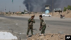 Iraqi security forces and Popular Mobilization Forces patrol in Tuz Khormato, which was evacuated by Kurdish security forces, 130 miles (210 kilometers) north of Baghdad, Iraq, Oct. 16, 2017. 