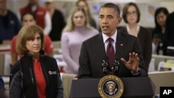 President Barack Obama, accompanied by American Red Cross President and CEO Gail J. McGovern, gestures while speaking during the his visit to the Disaster Operation Center of the Red Cross National Headquarter in Washington D.C. to discuss superstorm Sand