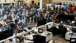 FILE - In this Jan. 2, 2015 photo, people line up at a California Department of Motor Vehicles office to register for drivers licenses in Stanton, California, where 59,000 driver's licenses were issued to immigrants who are in the U.S. illegally.