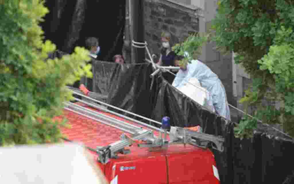 French police forensic experts and investigators exit a body, unseen, in Nantes, western France, from the house of a French family who have been missing since early April, Thursday, April 21, 2011. French police investigating the mysterious disappearance 