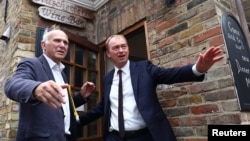 Liberal Democrat leader Tim Farron, right, and former Business Secretary Vince Cable, left, campaign for the forthcoming general election, in Twickenham, Britain, June 7, 2017.