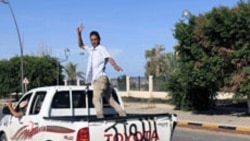 Anti-Gadhafi fighters in a vehicle after the fall of Sirte, October, 2011