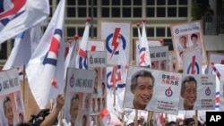 Supporters of the ruling People's Action Party (PAP), cheer their party leaders at a nomination center, Tuesday, Sept. 1, 2015.