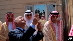 Iraq Foreign Minister Mohamed Alhakim raises the Saudi flag during the opening ceremony of the Saudi consulate in Baghdad, Iraq, April 4, 2019. 