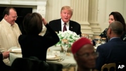 President Donald Trump joins an iftar dinner, which breaks a daylong fast, celebrating Islam's holy month of Ramadan, in the State Dining Room of the White House in Washington, Monday, May 13, 2019.