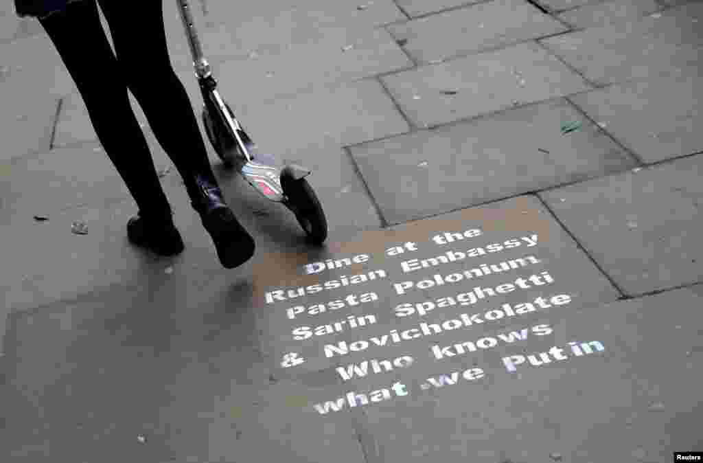Graffiti sprayed on the pavement near the entrance to the Russian embassy and ambassador&#39;s residence in London.