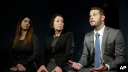 FILE - Christine Levinson (center) wife of Robert Levinson, and her children, Dan and Samantha Levinson, talk to reporters in New York, Jan. 18, 2016. 