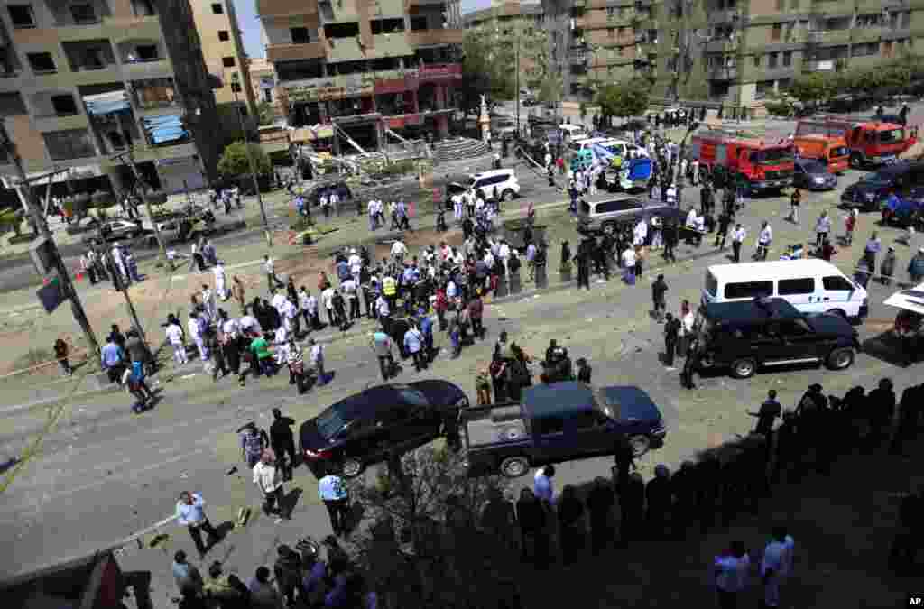 People gather at a site of an explosion near the convoy of the Egyptian Interior Minister Mohamed Ibrahim, Cairo, Sept. 5, 2013. 
