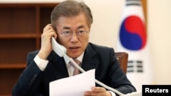 FILE - South Korean President Moon Jae-in speaks with Chinese President Xi Jinping by telephone at the Presidential Blue House in Seoul, South Korea, May 11, 2017.