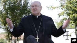 FILE - Bishop Kevin Farrell speaks to reporters outside the Diocese of Dallas Catholic Conference and Formation Center, in Dallas, Texas, Oct. 20, 2014.