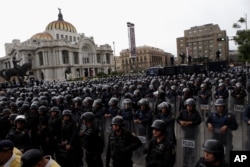 Police in riot gear block a protest march by teachers belonging to a dissident teachers union, in Mexico City, July 5, 2016.