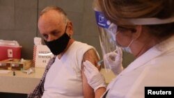 Hospital Chief Financial Officer Mitchell Thomas, 67, is given the coronavirus disease (COVID-19) vaccine at Martin Luther King Jr. Community Hospital, in South Los Angeles, California, U.S., December 17, 2020. REUTERS/Lucy Nicholson