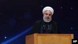 In this photo released by the official website of the office of the Iranian Presidency, President Hassan Rouhani speaks during a ceremony marking "National Day of Nuclear Technology," in Tehran, Iran, April 9, 2019.