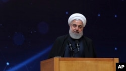 In this photo released by the official website of the office of the Iranian Presidency, President Hassan Rouhani speaks during a ceremony commemorating "National Day of Nuclear Technology," in Tehran, Iran, April 9, 2019.