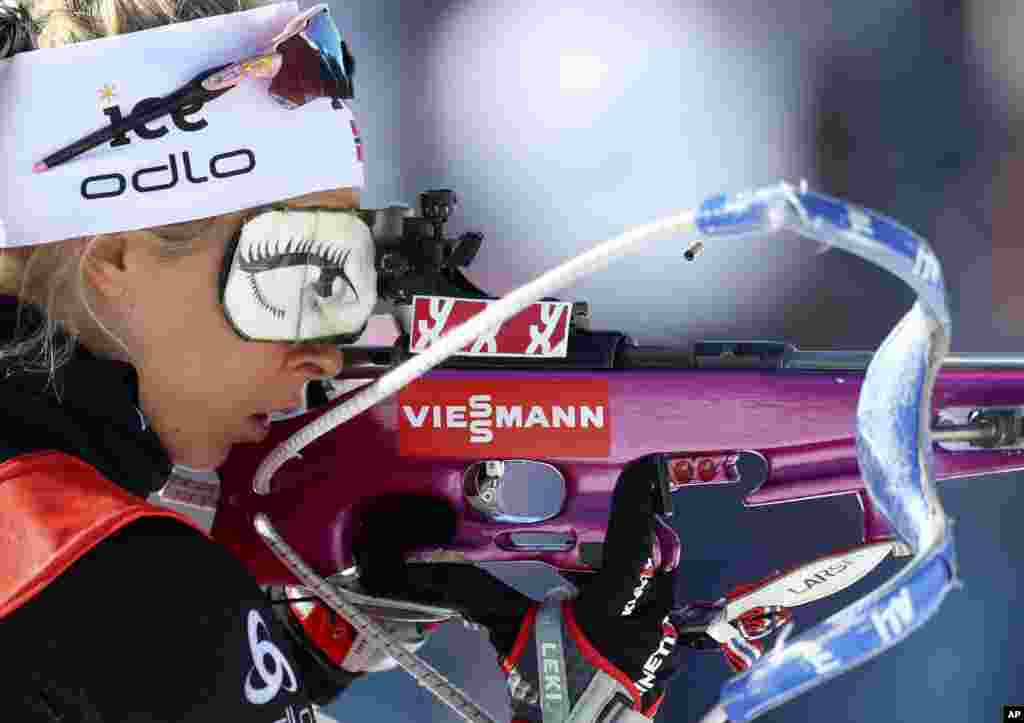 A spent cartridge pops out of the rifle of Ingrid Landmark Tandrevold of Norway during warmup before the women&#39;s 4x6 km relay competition at the Biathlon World Championships in Antholz, Italy, Feb. 22, 2020.