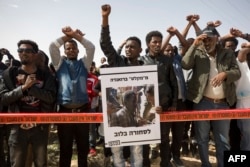 Asylum-seekers chant during a protest outside Israeli Prison Saharonim, in Negev desert, southern Israel, Feb. 22, 2018.