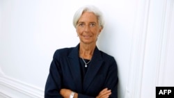 IMF chief Christine Lagarde poses on the sideline of a press conference, Aug. 27, 2014. 