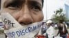 A Cambodian protester tapes his mouth shut in protest against discrimination of the Lesbian, Gay, Bisexual and Transgender (LGBT), in front of National Assembly, in Phnom Penh, file photo. 