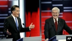 Republican presidential candidates former Massachusetts Gov. Mitt Romney, left, and former Speaker of the House Newt Gingrich, right, during the Republican debate, in Des Moines, Iowa, December 10, 2011.