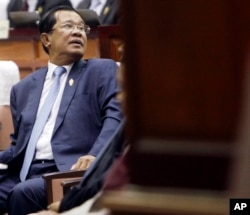 FILE - Cambodia's Prime Minister Hun Sen waits in the hall of National Assembly before a meeting, in Phnom Penh, Cambodia, Feb. 20, 2017.