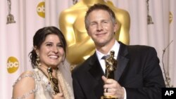 Sharmeen Obaid-Chinoy, left, and Daniel Junge pose with their awards for best documentary short for 'Saving Face' during the 84th Academy Awards in the Hollywood section of Los Angeles, February 26, 2012.