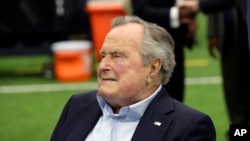 FILE - Former President George H.W. Bush arrives for an NFL football game between the Houston Texans and the Indianapolis Colts, Nov. 5, 2017, in Houston.